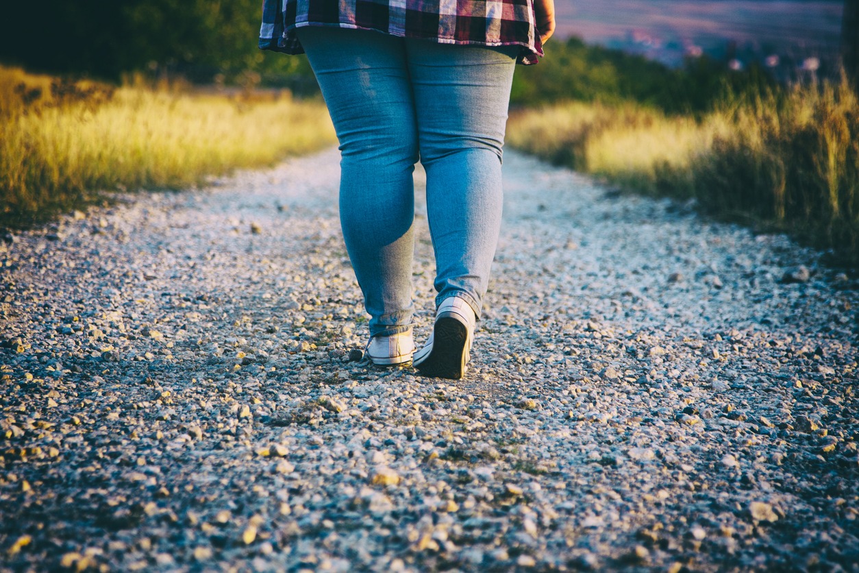 Young woman walking on country road